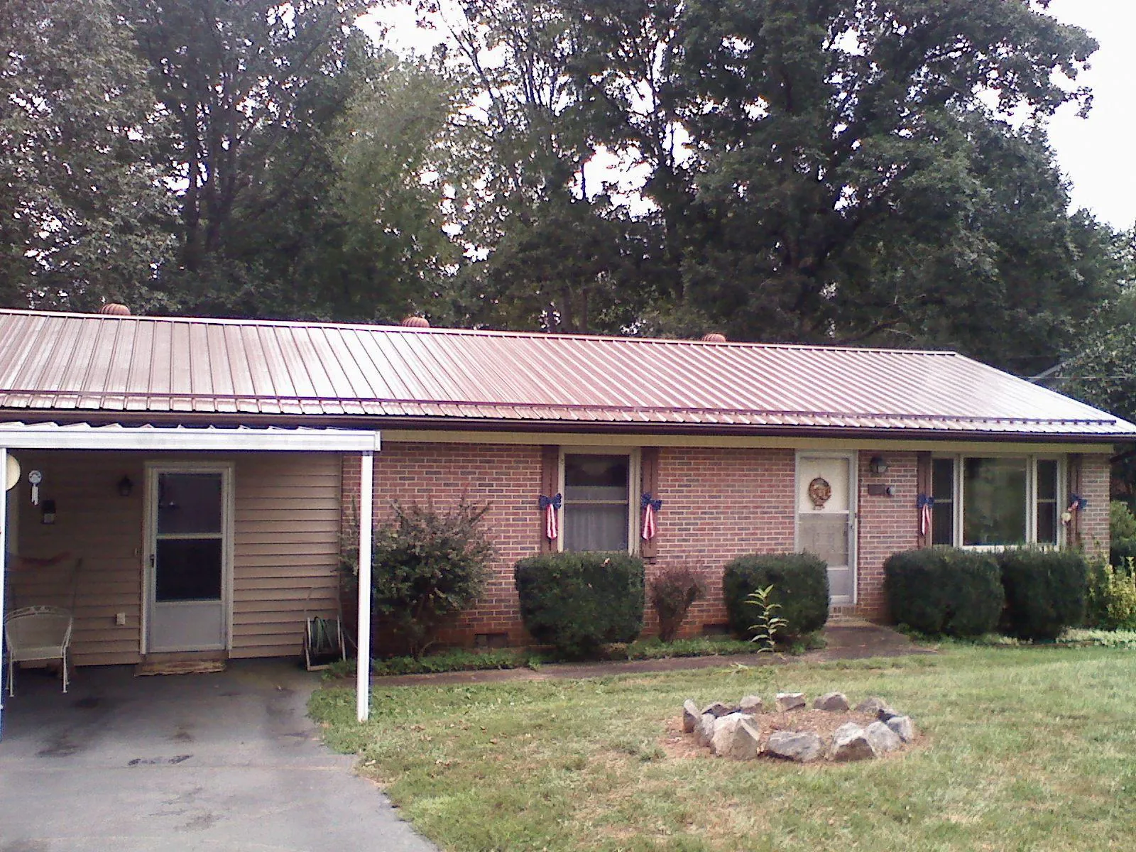 Bronze metal roof and carport on a brick ranch home — Roof Repair work by our crew in Chanhassen